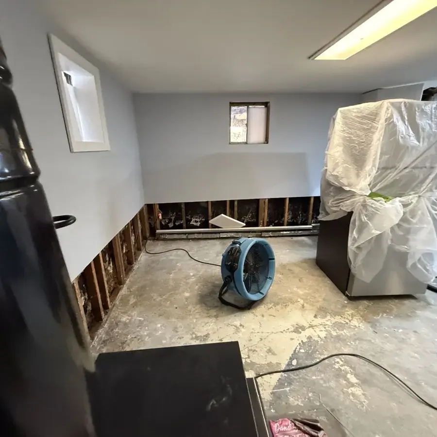 Air mover drying a lower level after a flood cut in Huntington Station, NY