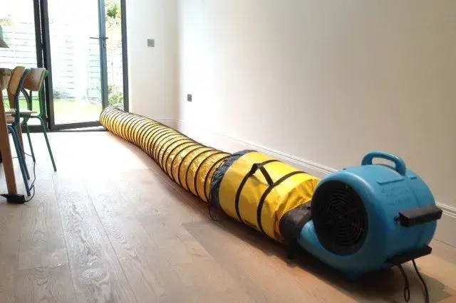 Air mover and duct drying a room with hardwood floors in Huntington Station, NY