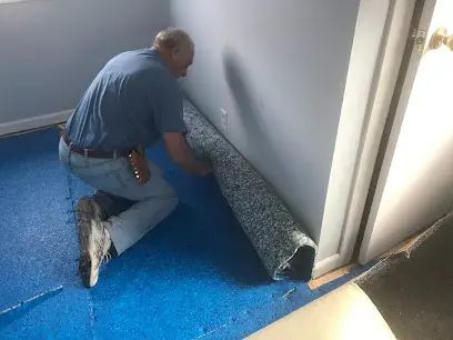 Wet carpet being rolled up for removal in Huntington Station, NY