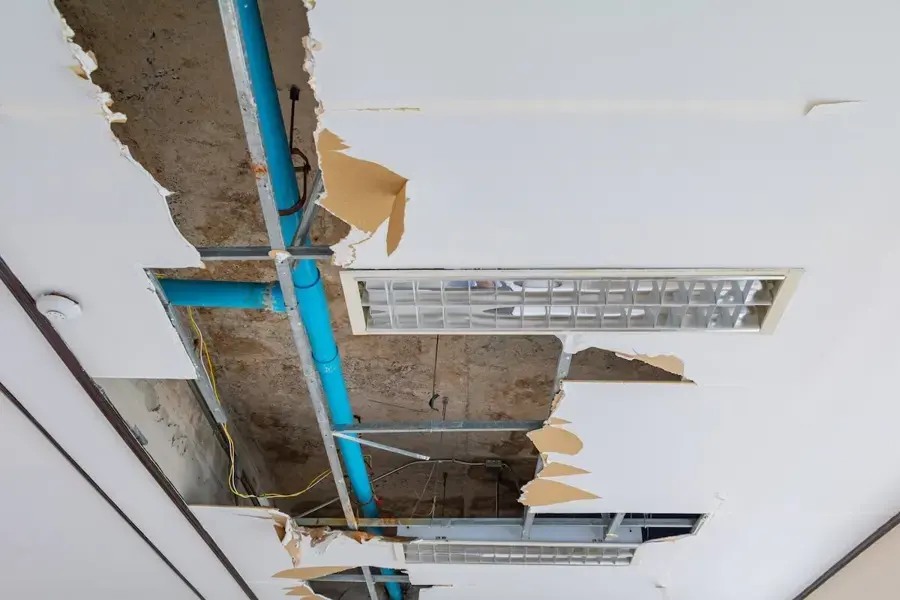 Ceiling opened to reach a leaking supply pipe in a Huntington Station, NY home