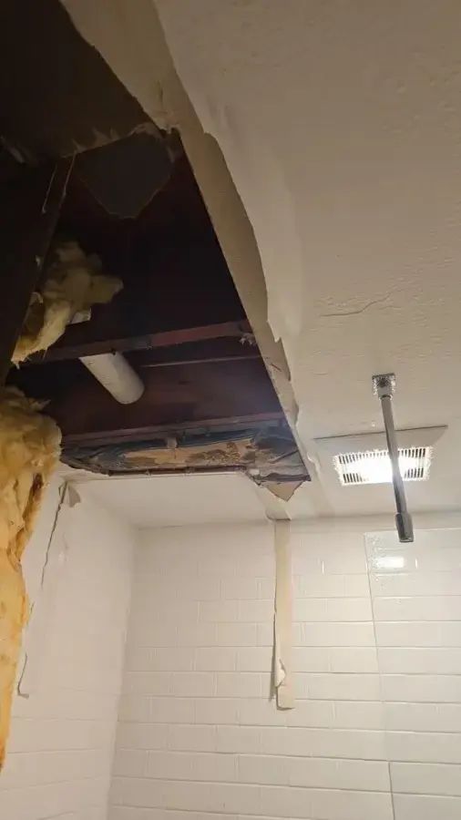 Ceiling opened around a split pipe and wet insulation in Huntington Station, NY