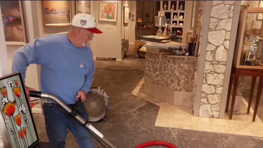 Storm water being vacuumed off a floor in a Huntington Station, NY home