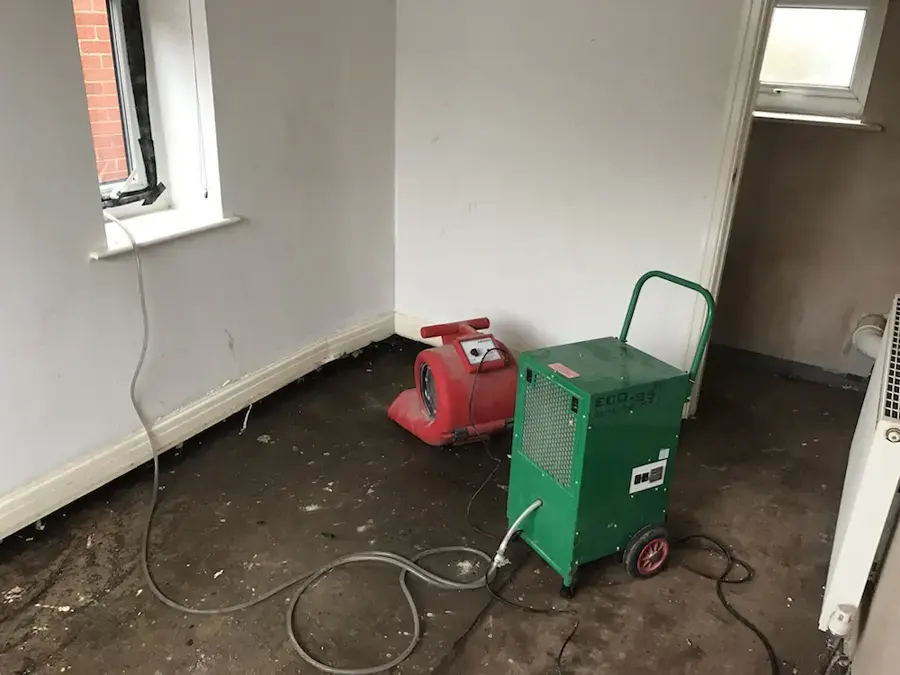 Air mover and dehumidifier drying a room after the flooring came out in Huntington Station, NY